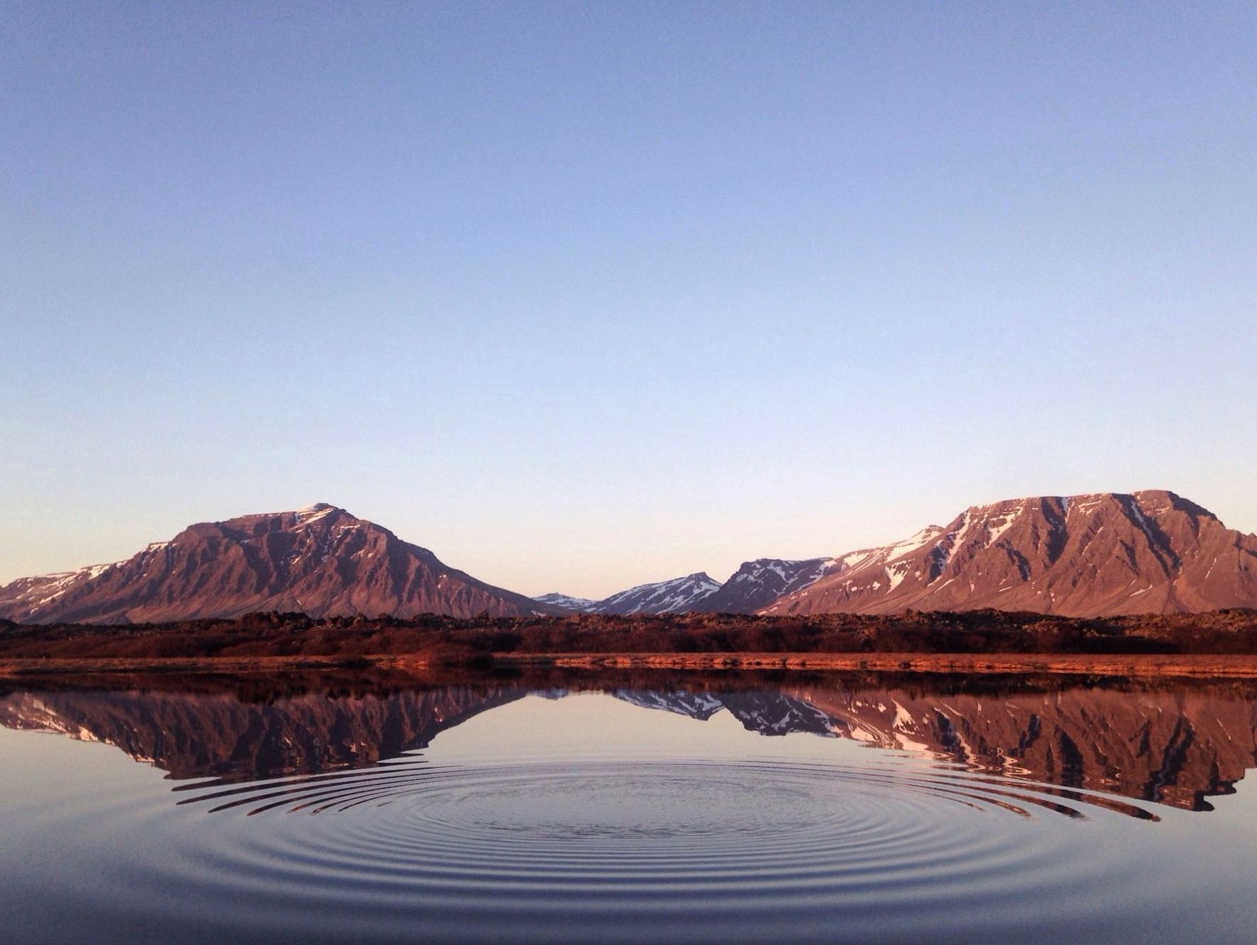 Majestic New Zealand fjord beneath steep green mountains